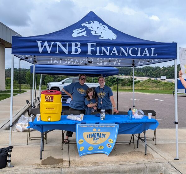 Volunteers running the lemonade day stand during the Boys and Girls Club event